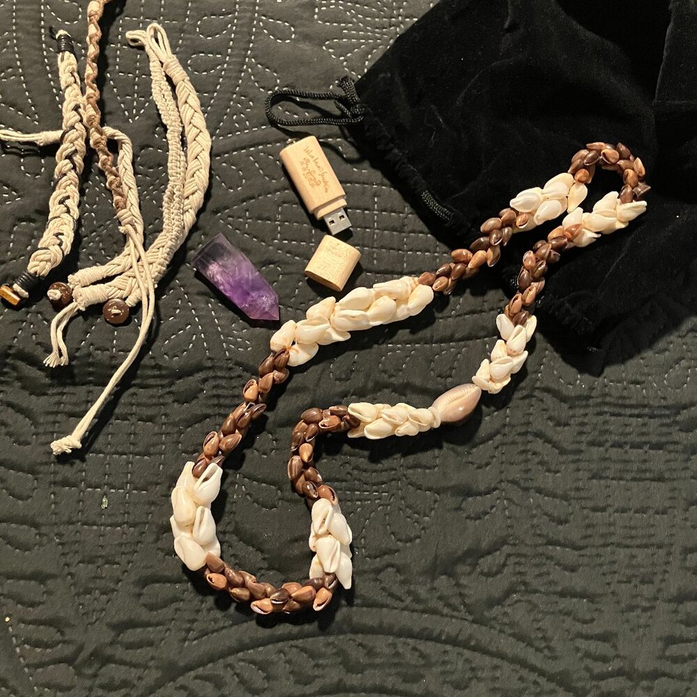 Hawaiian Puka necklace, 5 bracelets, a purple crystal, and a thumb drive